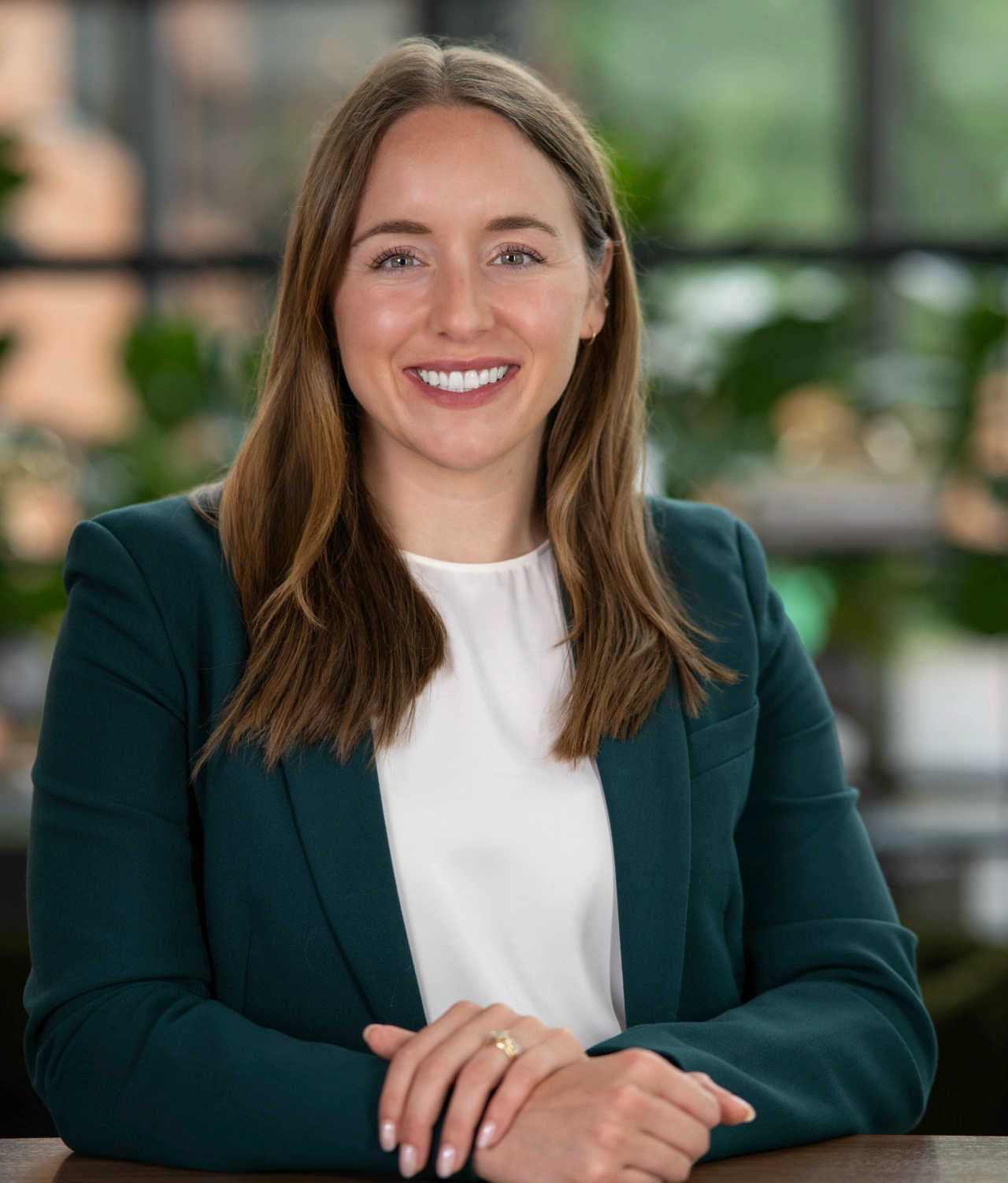 Dr. Jennifer Shehan in her offices wearing a green jacket