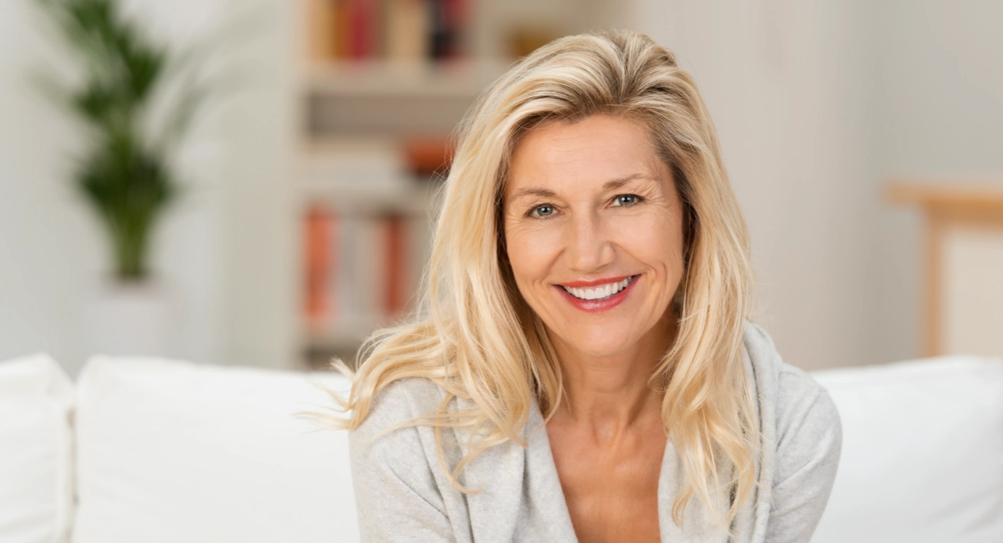 mature blonde woman, smiling into the camera