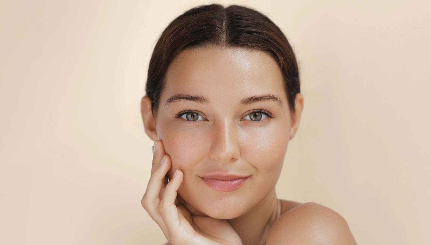young woman touching her face